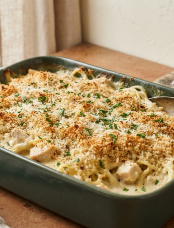 creamy pasta and chicken in a forest green